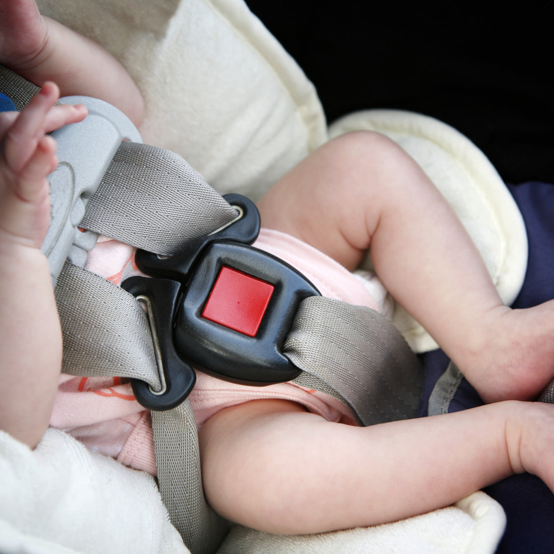 Baby buckled into a car seat