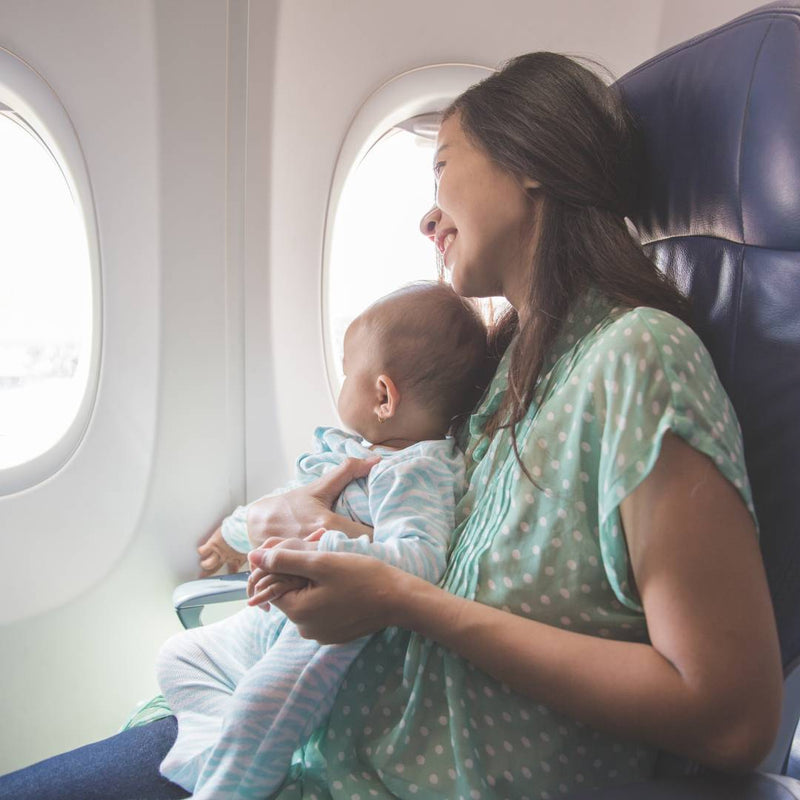 Baby and mother travelling on a plane