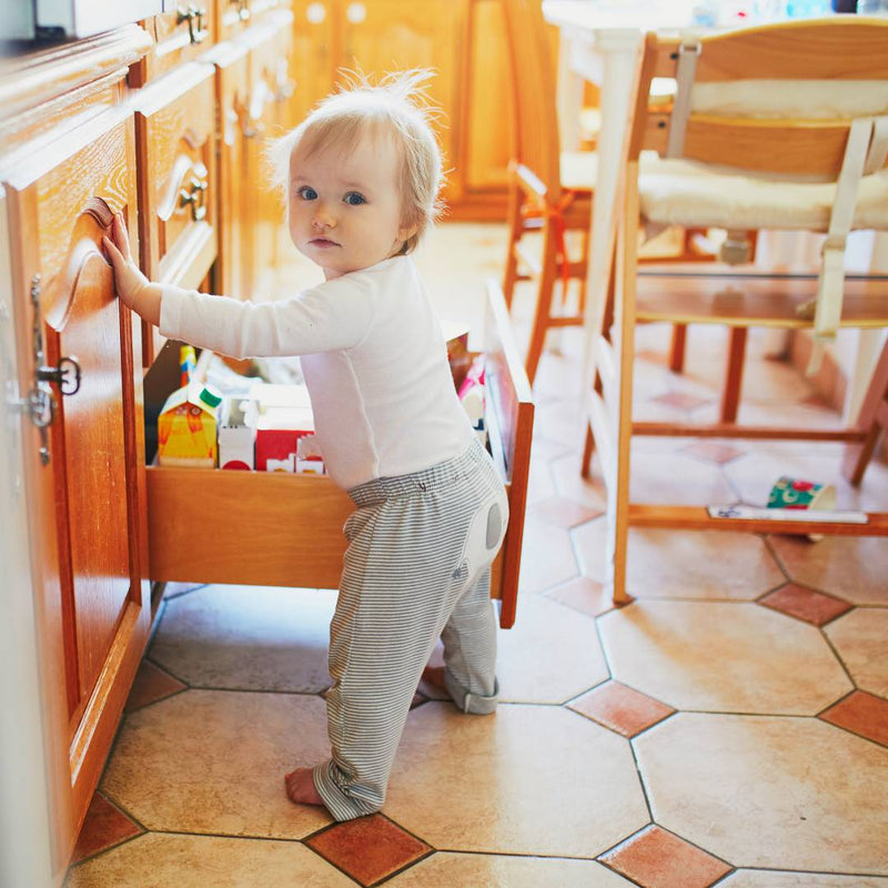 Toddler opening kitchen drawer