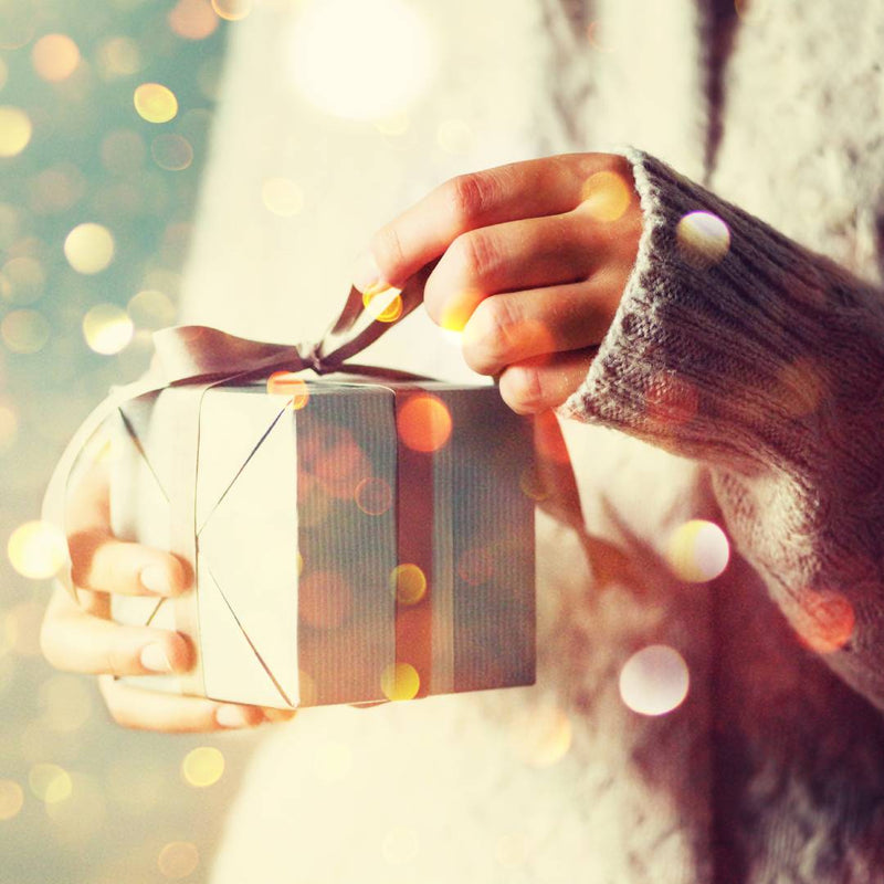 Hands opening a gift